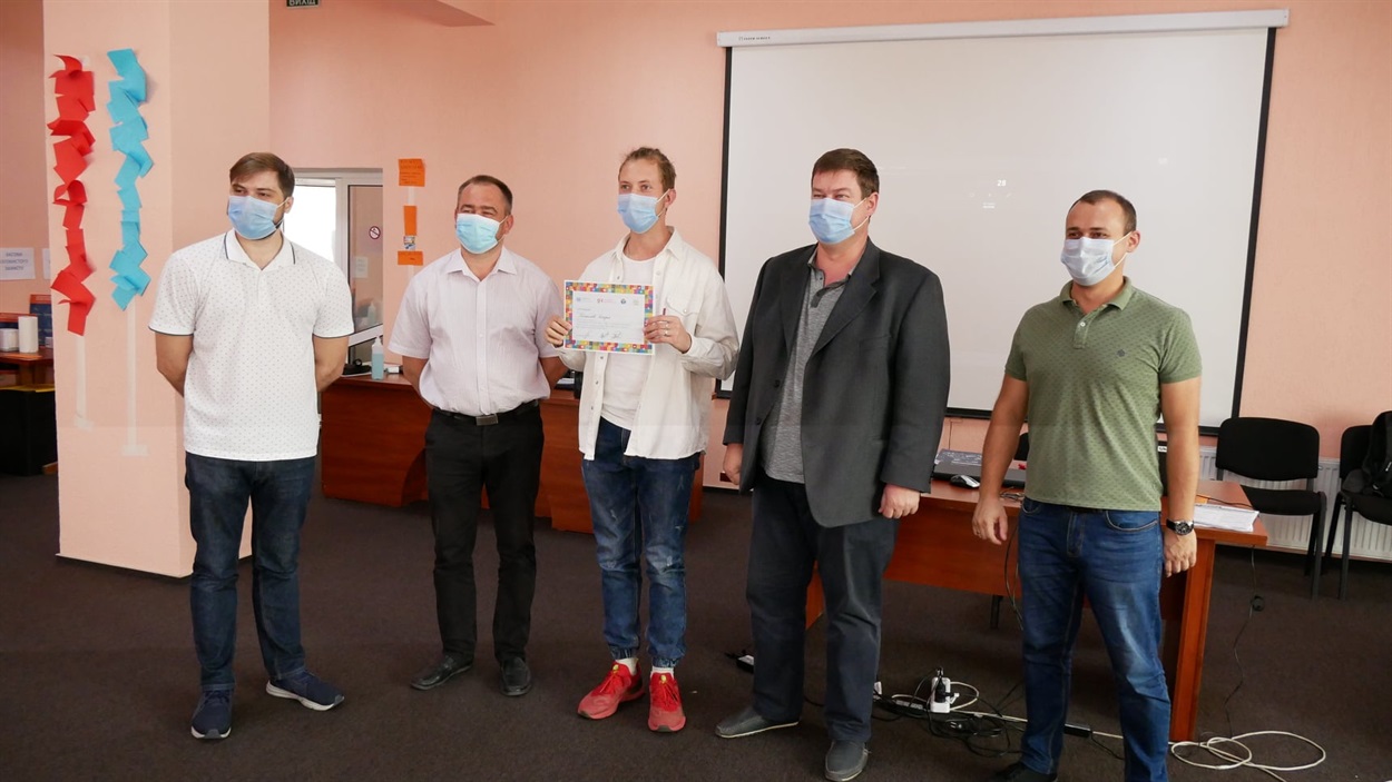Евгений Назаров с коллегами получают сертификат о прохождении тренинга от ПРООН