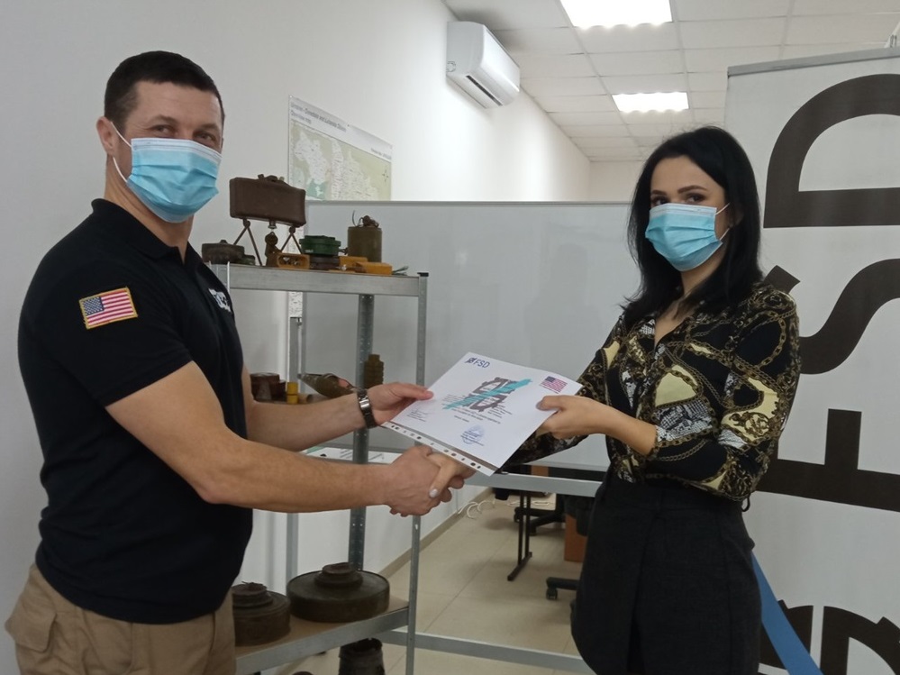 Микола Дячук вручає сертифікат учасниці тренінгу з демінування